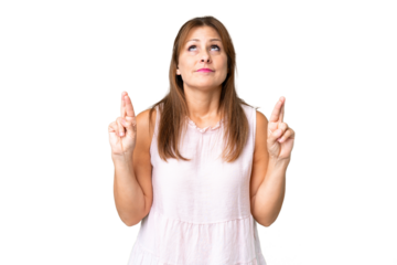 Middle age woman over isolated background with fingers crossing and wishing the best