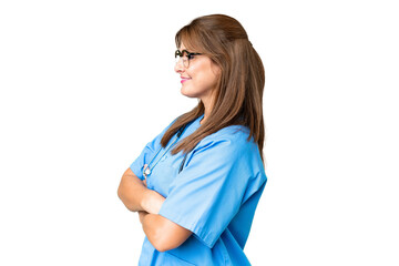 Middle age nurse woman over isolated background in lateral position