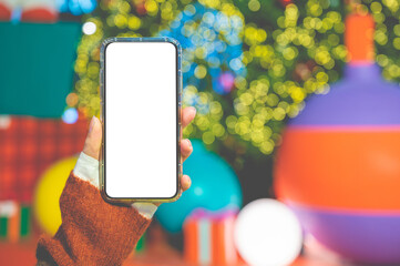 Close up women using a smartphone with an empty white screen at  night festival event.