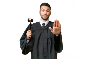 Judge caucasian man over isolated background making stop gesture