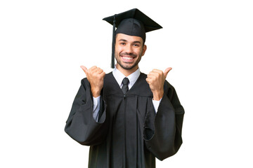 Young university graduate man over isolated background with thumbs up gesture and smiling