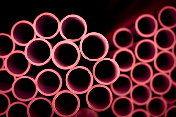 Background of the pink plastic pipes in stacked