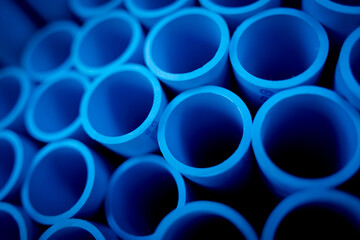 Background of the blue plastic pipes in stacked - obrazy, fototapety, plakaty