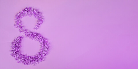 Figure 8 made of flowers on pink background. Happy International Womens Day celebrate on March, congratulatory card
