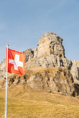 Waving swiss flag on top of the Klausenpass in Switzerland