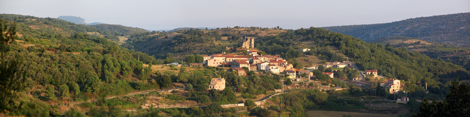 Fototapeta na wymiar Panoramic view of Le Vivier village with its medieval castle ruin in the morning, Occitanie in France