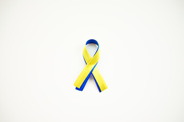 yellow blue ribbon on a white background. a sign of support for Ukraine. colors of the Ukrainian flag. we stand with Ukraine