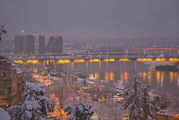 View from Kalemegdan park to the Branko's Bridge and building under construction in the city of Belgrade Waterfront project. Winter scene at evening.