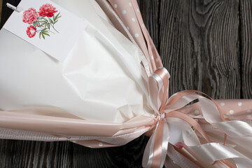 Elements of marshmallow bouquet. Ribbons and company labels. Packed in paper in the form of a bouquet. Close-up.