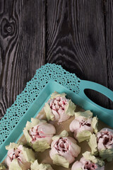 Zephyr tulips. Natural homemade marshmallow. Arranged on a tray. Close-up.