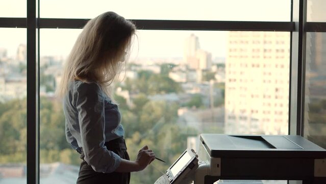 Secretary sending fax via email and printing document