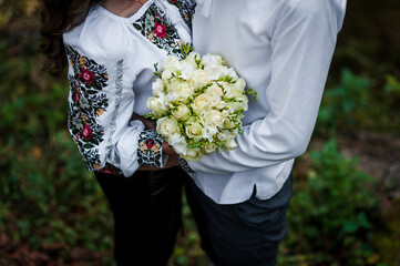 A bouquet of flowers in the hands of the bride. A bouquet of white flowers in the hands of a woman. Wedding