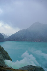 Ijen volcano crater in indonesia with acid lake