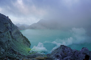 Ijen volcano crater in indonesia with acid lake