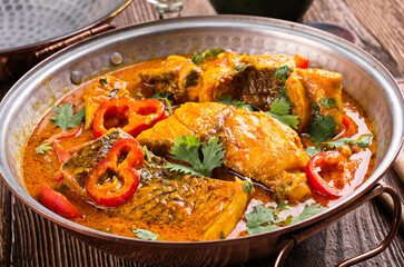 Traditional Portuguese cataplana fish stew with seafood and vegetable in spice sauce served as top view in a Algarve stew pot