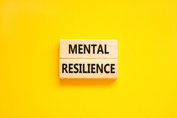 Mental resilience symbol. Concept word Mental resilience typed on wooden blocks. Beautiful yellow...