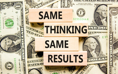 Same thinking and results symbol. Concept word Same thinking same results on wooden blocks. Beautiful background from dollar bills. Business and same thinking and results concept. Copy space.