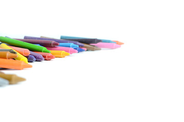 Crayons lined up isolated on white background.