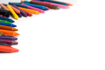 Crayons lined up isolated on white background.