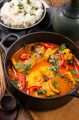 Traditional Brazilian moqueca de peixe fish stew with seafood, vegetable and rice in spice sauce...