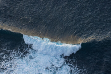 Great waves illuminated by the sun during sunset. Great waves that are perfect for surfing. © Philip