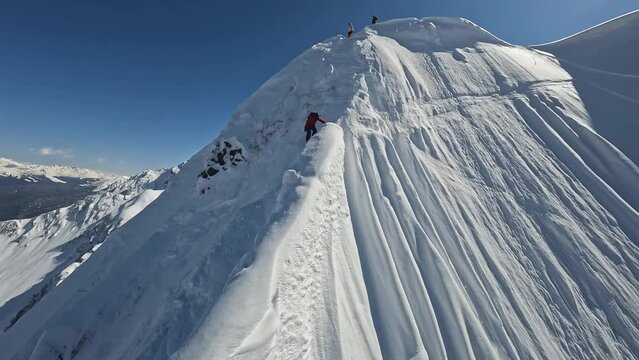 Professional snowboarding rider freeride mountain ridge snowy splash slope extreme sport leisure activity aerial view. Man red jacket riding snowboard jumping maneuver cliff peak freestyle vacation 4k