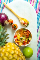 Fototapeta na wymiar Top view of nutritious serving of mexican pineapple salsa