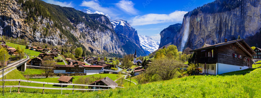 Wall mural amazing landscape of switzerland alps mountains and charming villages. iconic village with waterfall