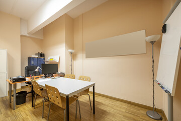 Work tables in an office with a blackboard of deleble markers
