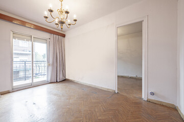 Fototapeta premium Empty room with aluminum windows leading to a terrace, hanging arm lamp and access to another room