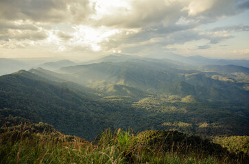 green mountain view with sun ray in cloudy day
