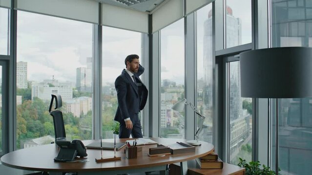 Worried manager walking office trying to solve corporate financial problems.