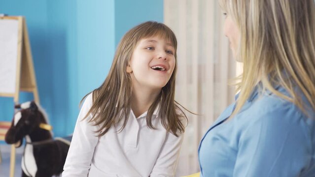 Cute little girl is telling her mother, talking to her.
Happy and cheerful little girl is telling something to her mother, expressing her problems, wishes.
