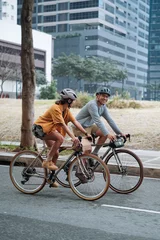 Foto op Canvas A young couple riding their bikes together in the city. © Jonathan De Guzman
