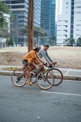 A young couple riding their bikes together in the city.