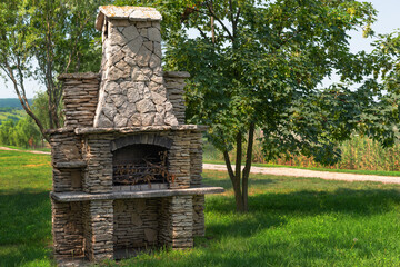 Stone garden oven for grill or barbeque is in a backyard