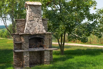 Deurstickers Stone garden oven for grill or barbeque is in a backyard © izikmd
