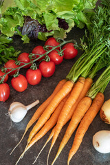 Farm vegetables (tomatoes, carrots, lettuce) on the table