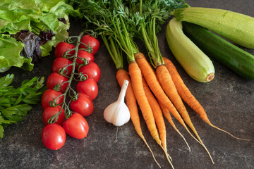 Farm vegetables (tomatoes, carrots, lettuce) on the table