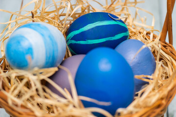 Fototapeta na wymiar Painted blue easter eggs in a basket
