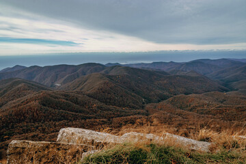 Stunning view of the mountain landscape. View from a height of 1000 m on the mountain peaks of the Black Sea coast of the Caucasus. Stunning view of the mountain landscape from a height.