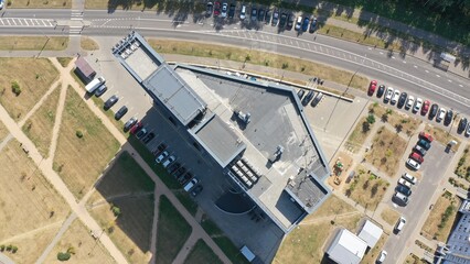 Top view of the roof of a tall office building, shopping mall. The infrastructure of a skyscraper on the roof: ventilation shafts, blowers, hoods, antennas, communication towers, satellite dishes.