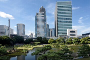 The Kyū Shiba Rikyū Garden - a public garden and former imperial garden in Minato ward in Tokyo, tall skyscrapers in the background