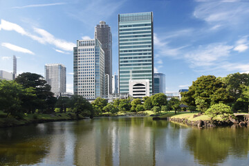 Fototapeta premium The Kyū Shiba Rikyū Garden - a public garden and former imperial garden in Minato ward in Tokyo, tall skyscrapers in the background
