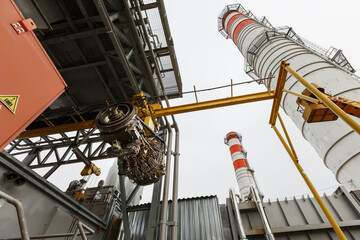 Perform a lift to install a new turbine engine for a power plant © Alexander