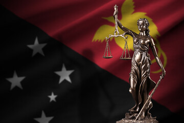 Papua New Guinea flag with statue of lady justice and judicial scales in dark room. Concept of...