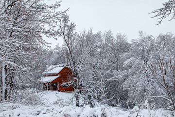 Log cabin after a December snow storm in Wisconsin