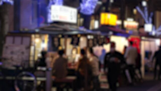 NAKASU, HAKATA, FUKUOKA, JAPAN - NOVEMBER 2022 : View of STREET FOOD STALLS (Yatai) in Nakasu area at night. Open air food stands are the Fukuoka city's famous symbol.