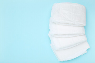 Baby diapers on blue background