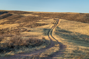 dirt ranch road in grassland in northern Colorado, early spring scenery of Soapstone Prairie...